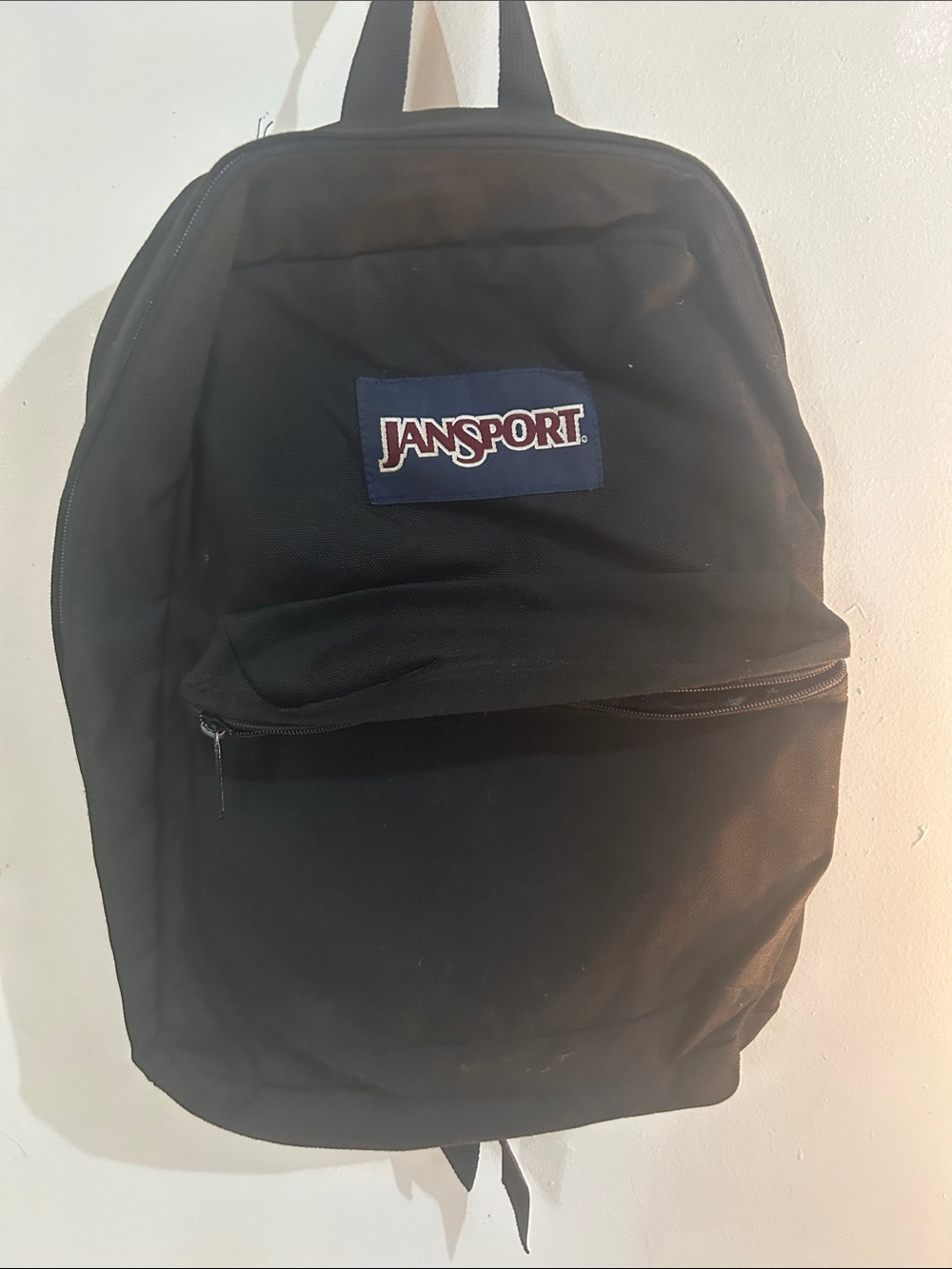 Jansport Black Backpack with Navy Logo Patch